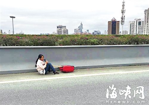 女子被拽下后，坐在三環路應急車道上喝水